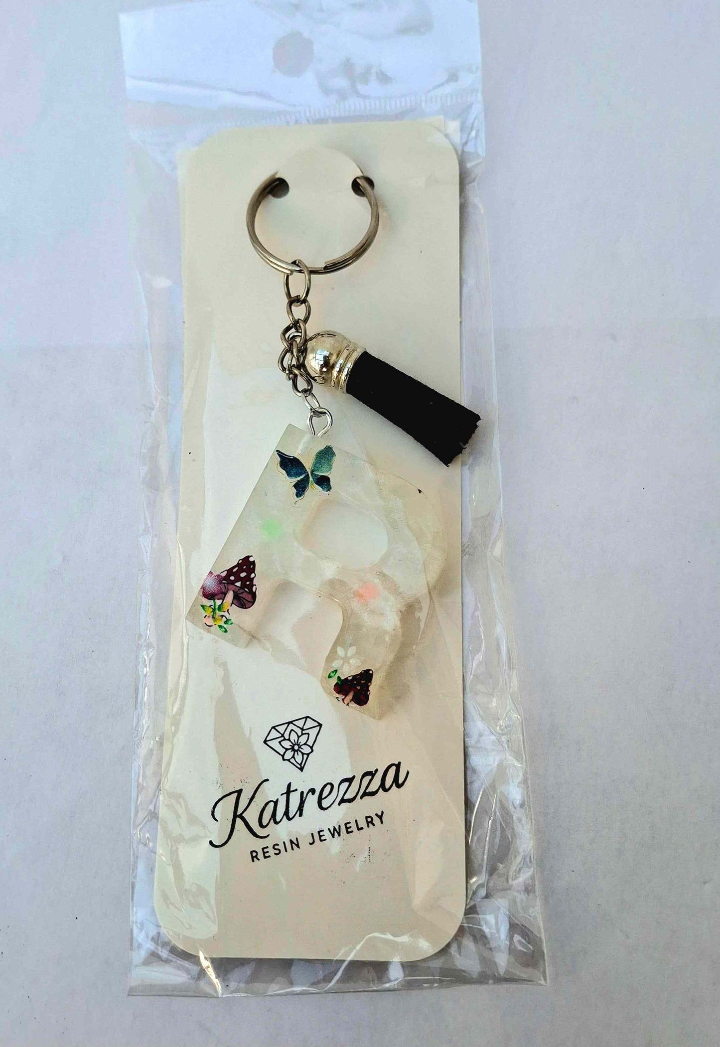 Packaged resin letter R keychain by Katrezza