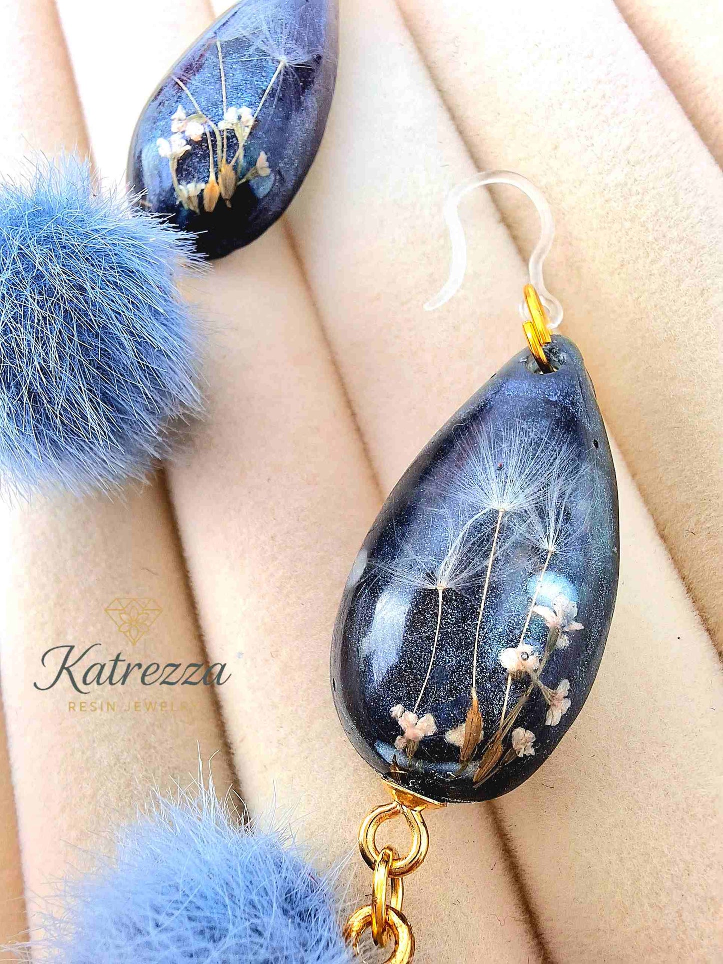 "Pair of handmade resin teardrop earrings with preserved flowers, dandelion seeds, and fluffy blue pom-poms – Katrezza Jewelry"