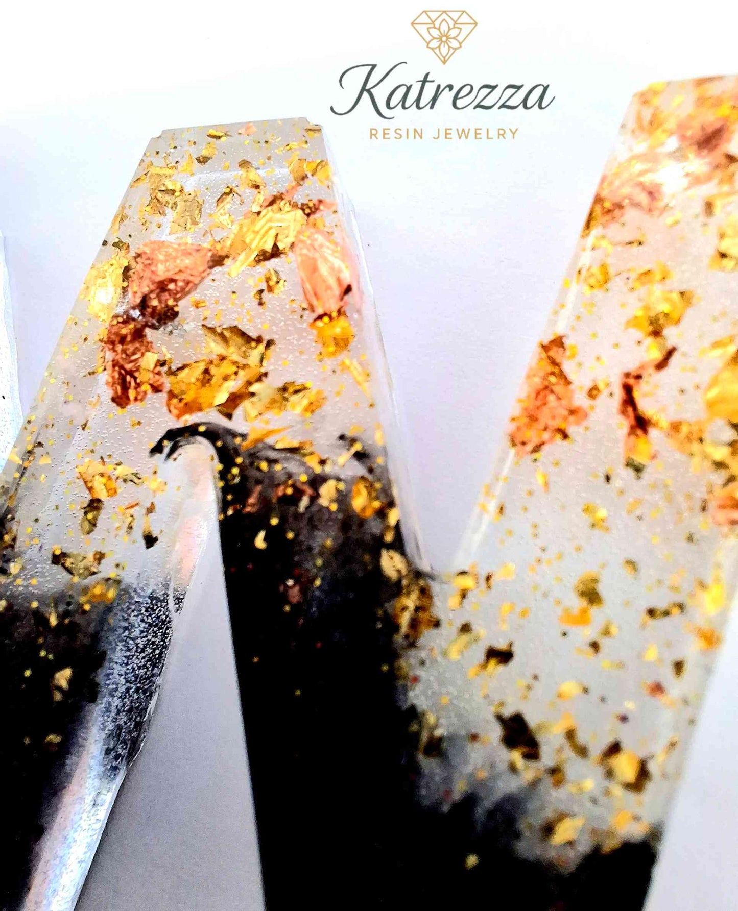 Full resin W keychain with gold foil flakes and silver keyring.