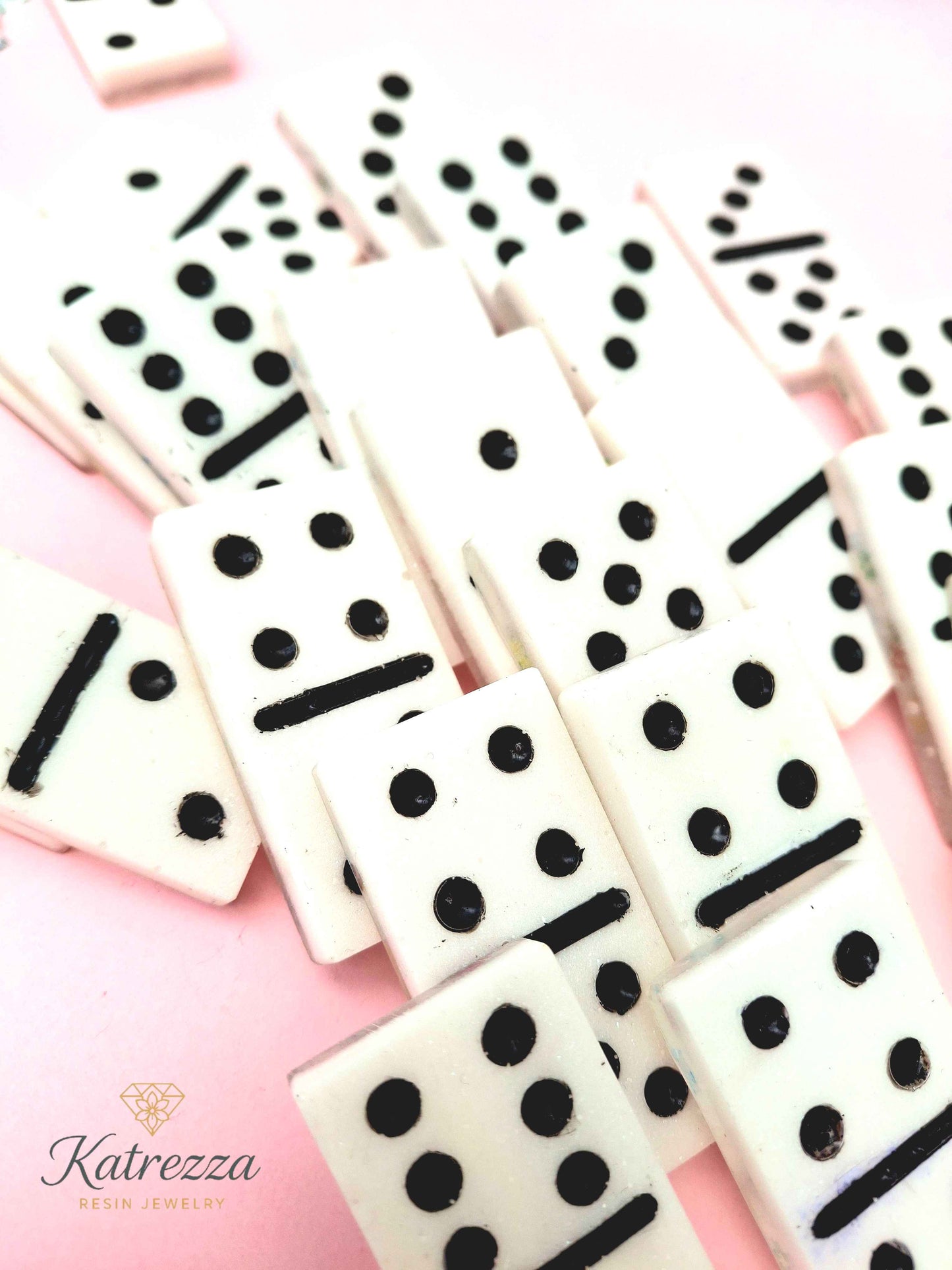Close-up of resin dominoes with engraved black pips