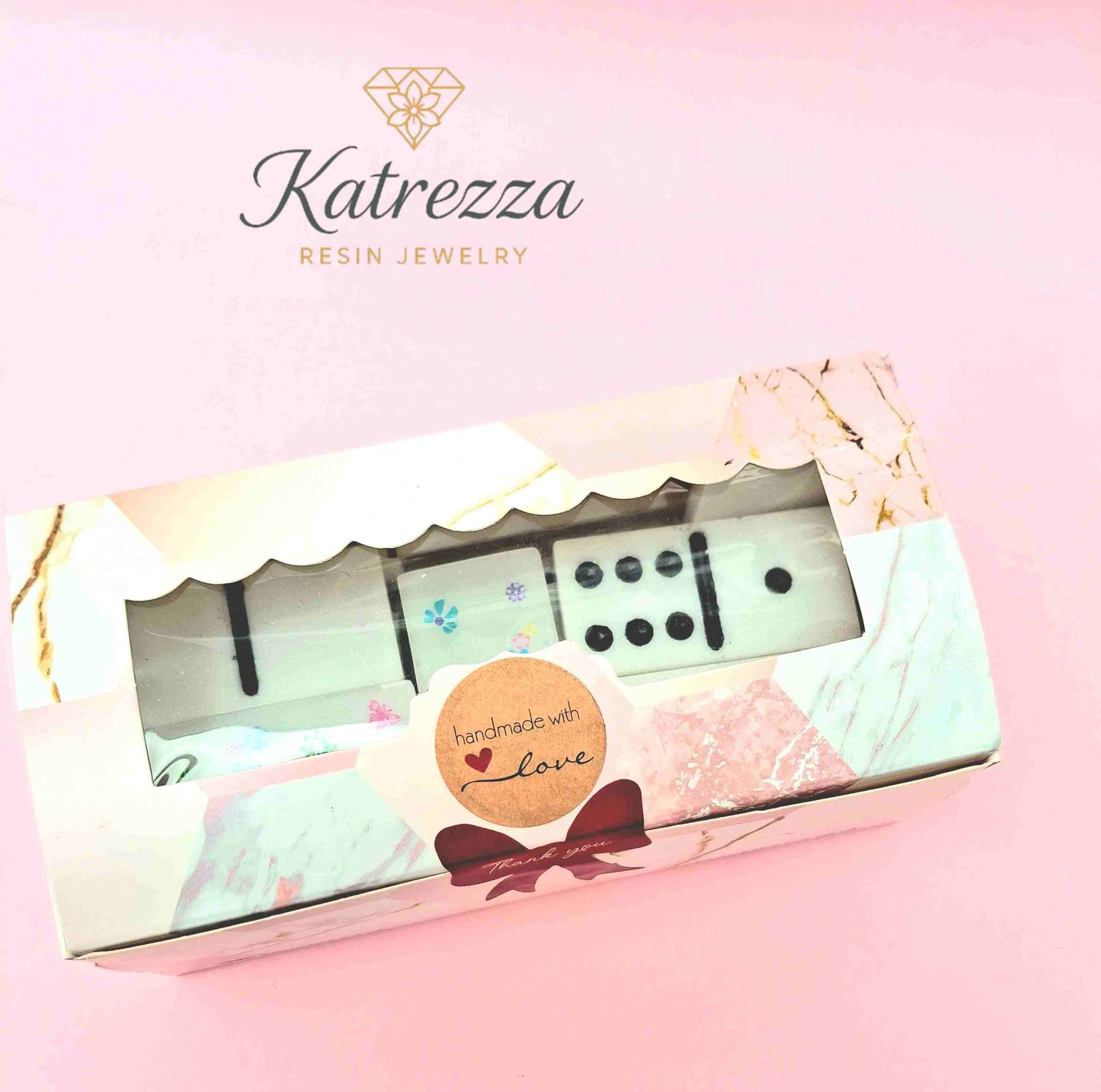 Close-up decorative resin domino with roses, bows, and hearts