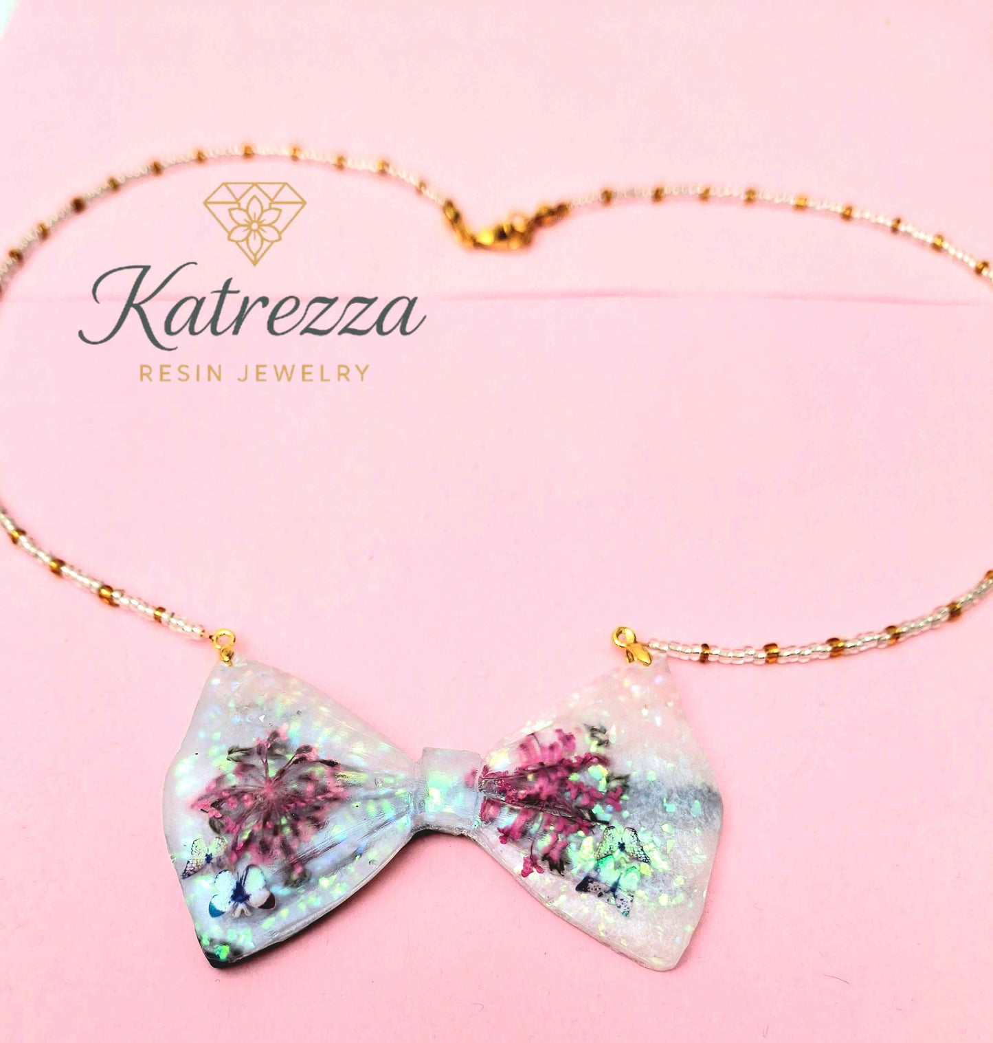 Resin necklace with white bow and pink flowers