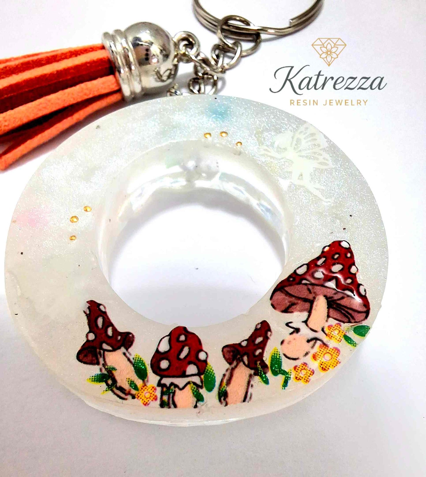 Glow-in-the-dark resin O keychain with mushrooms and fairy accents.