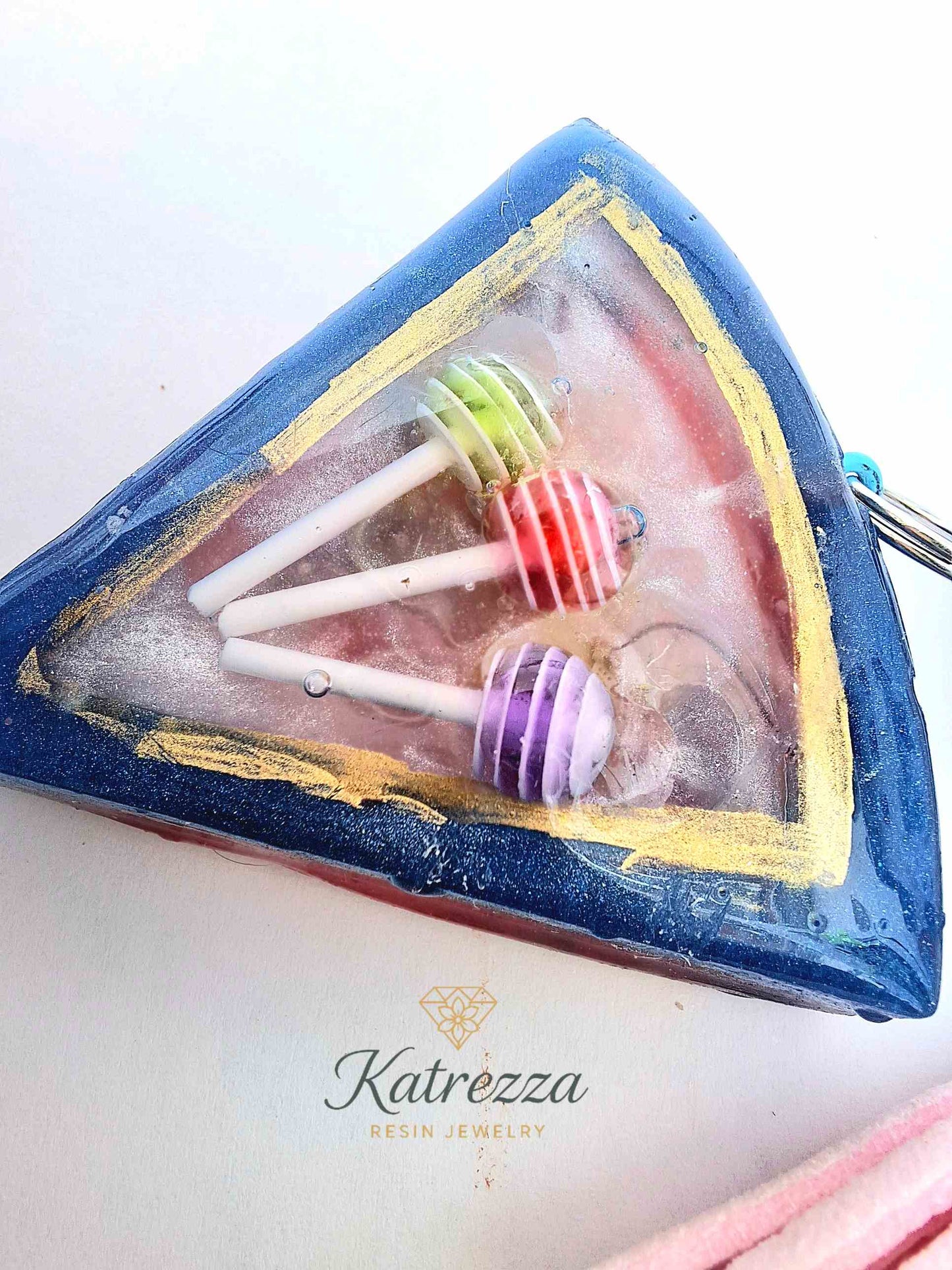 "Close-up of resin slice keychain with colorful lollipops inside"