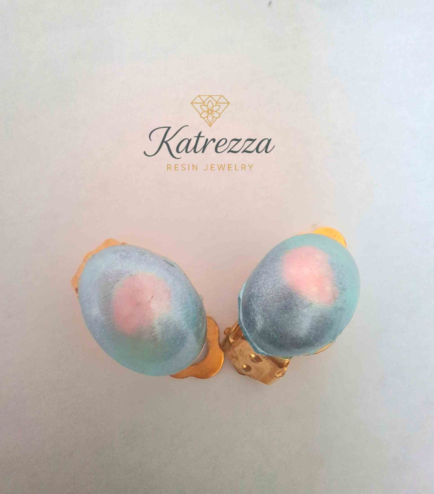 “Blue and pink handmade resin clip-on earrings with gold fastening – Katrezza kids jewellery.”