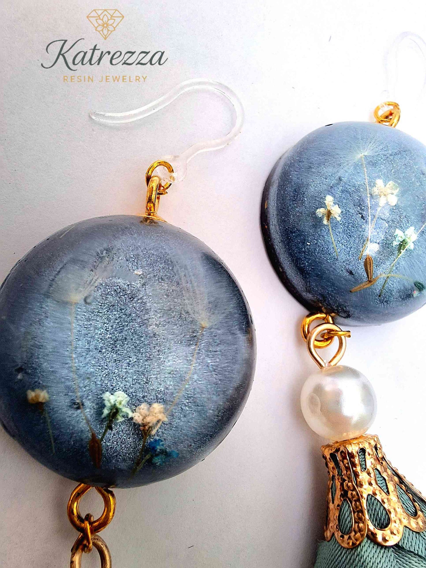 “Pair of handmade resin earrings with flowers inside resin, pearl accent, and green tassel, hypoallergenic hooks – lightweight jewelry.”