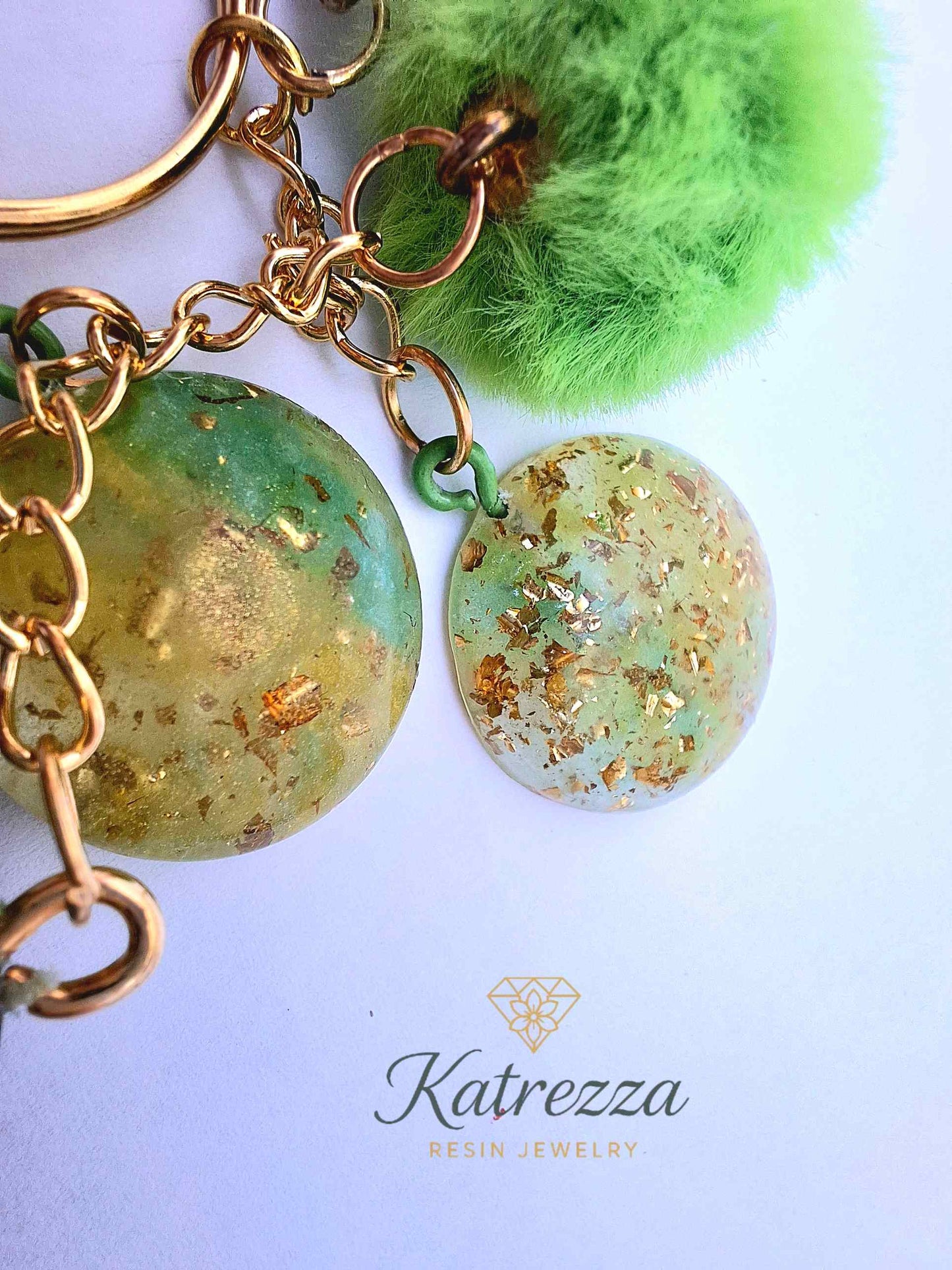"Close-up of resin heart charm with LOVE inscription and floral details – Katrezza Resin Keychain"