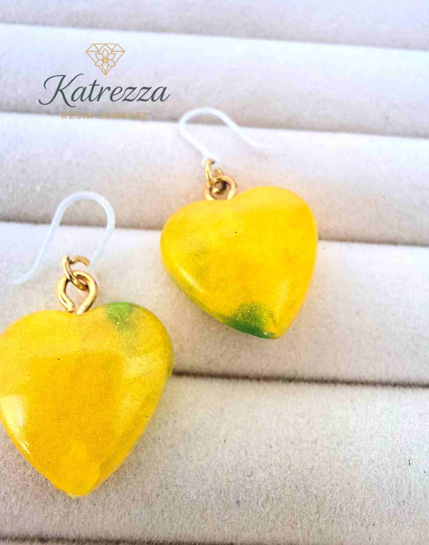 "Detailed close-up of small yellow resin heart earring with hypoallergenic silicone hook – Katrezza Girls Collection"