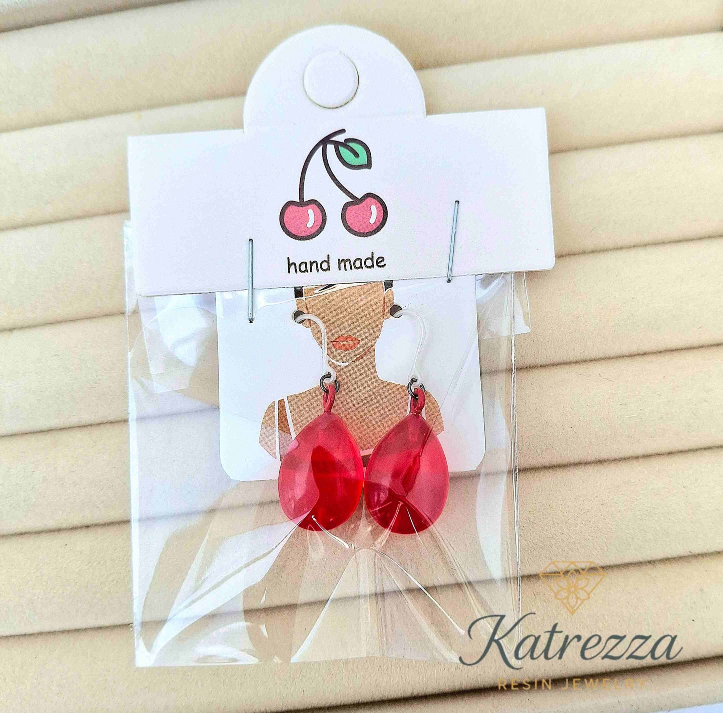 Handmade red resin teardrop earrings in gift packaging