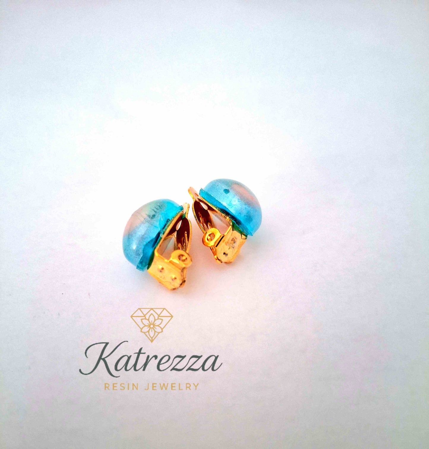“Resin clip-on earrings for girls – blue and pink design with gold clips, handmade by Katrezza.”