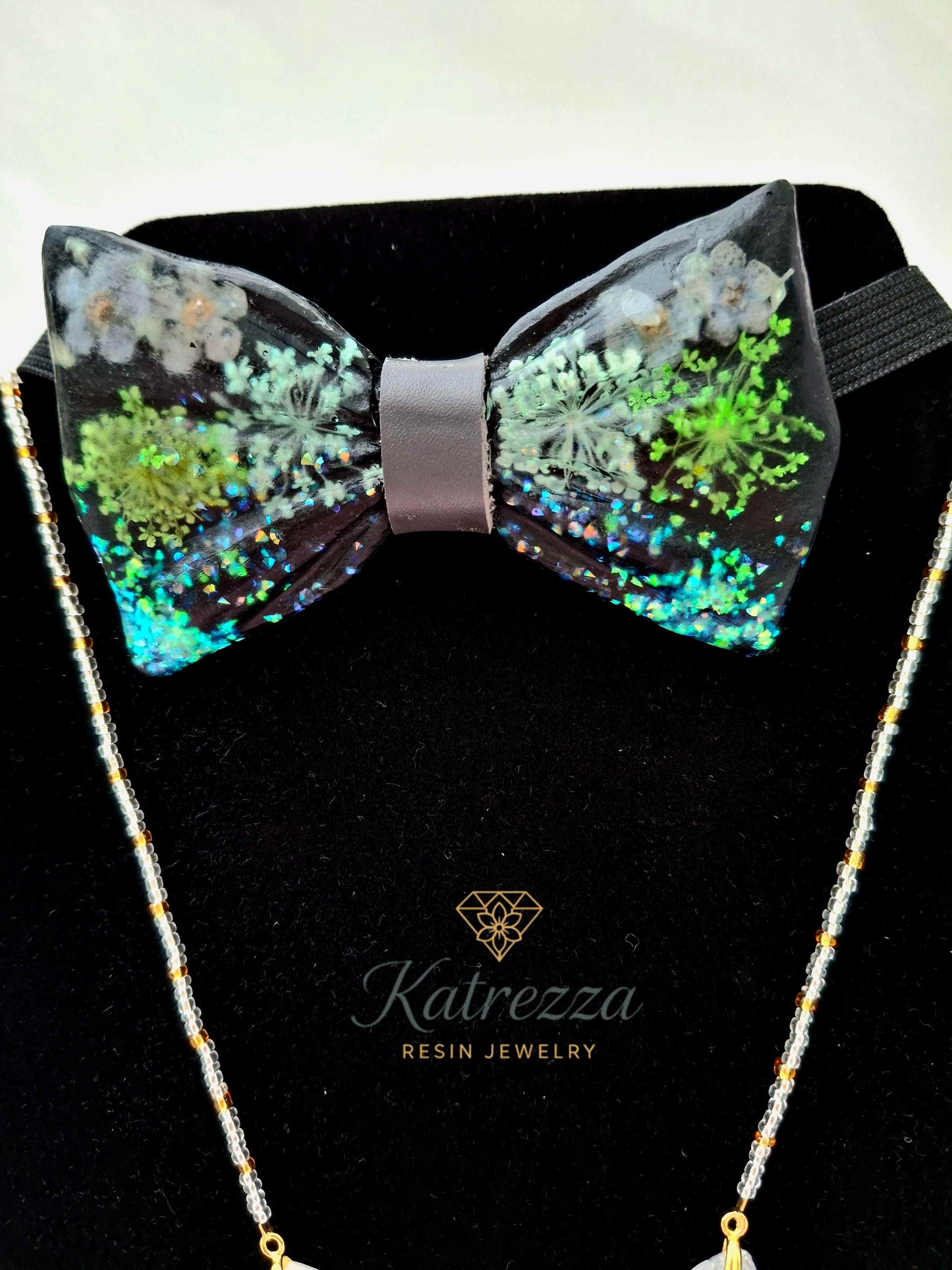 Resin bow tie with flowers on black strap