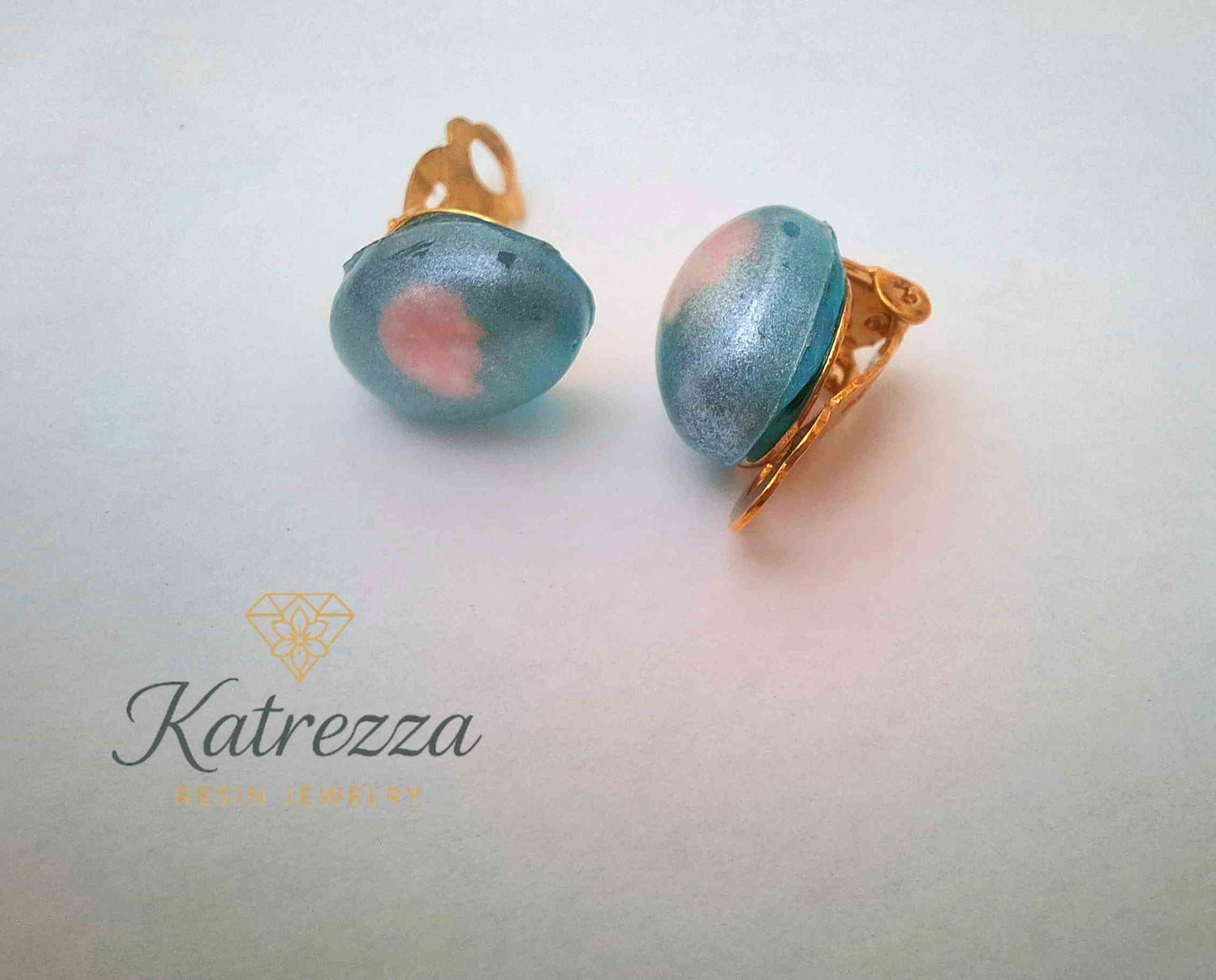 “Playful resin clip-on earrings for kids – mixed designs including blue-pink and LOVE heart styles.”