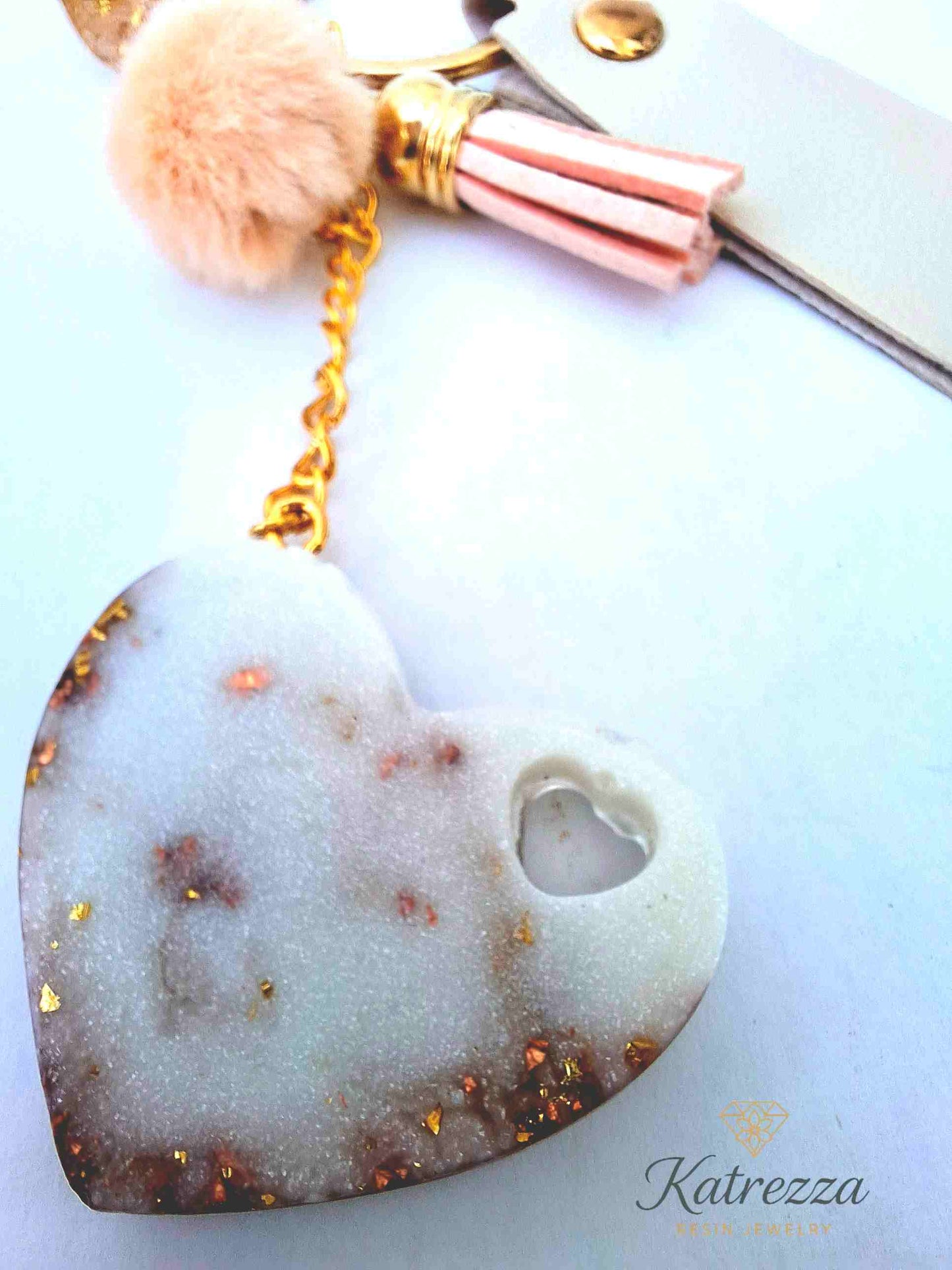 "Back view of resin heart keychain with shimmering gold flakes and heart cutout – Katrezza Luxurious Collection"