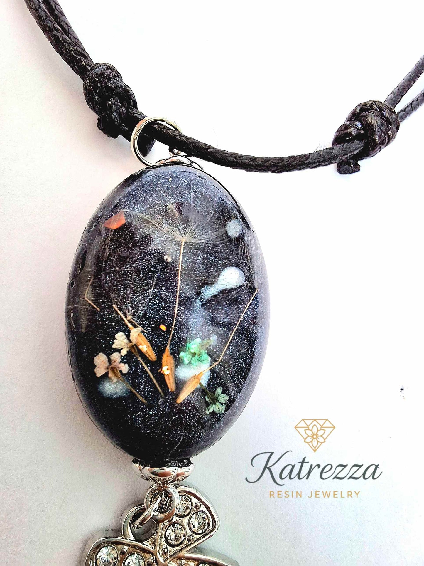 “Handmade resin pendant with tiny Queen Anne’s Lace flowers and dandelion seeds preserved inside black resin – Katrezza artisan jewelry
