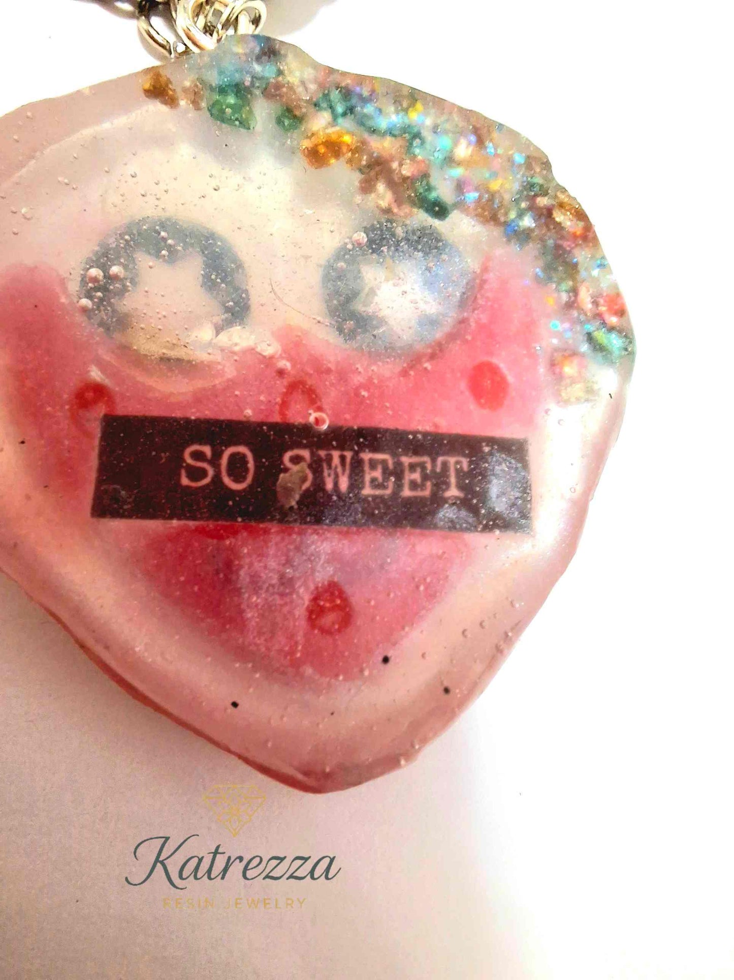 Kawaii resin keychain with starry eyes and red heart smiley face, handmade from The Imperfects Collection at Katrezza Resin Jewelry.