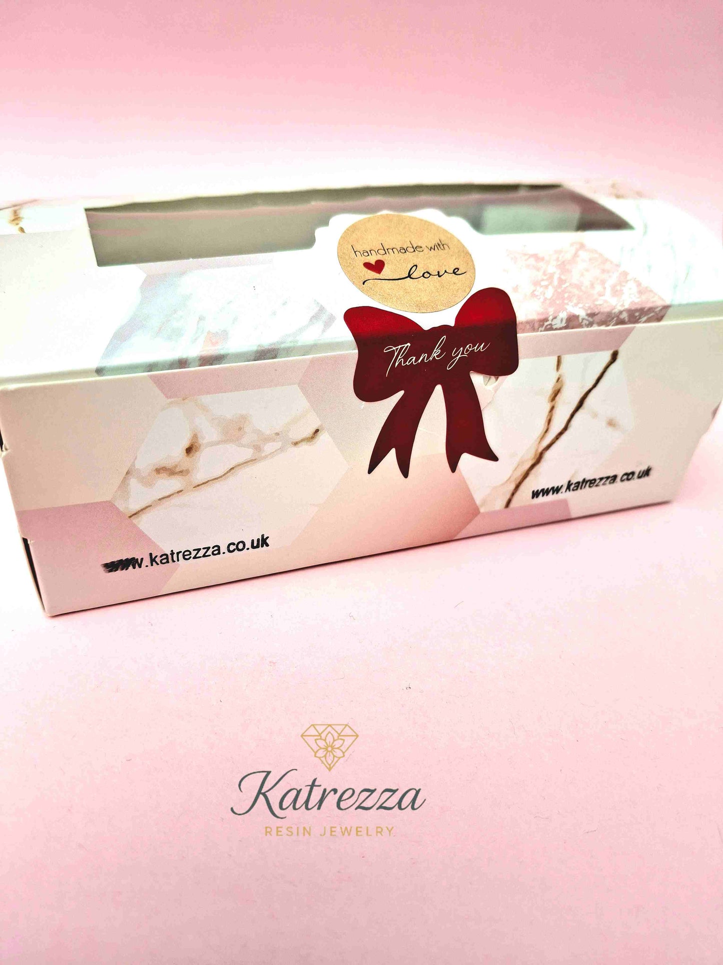 Close-up decorative resin domino with roses, bows, and hearts
Packed