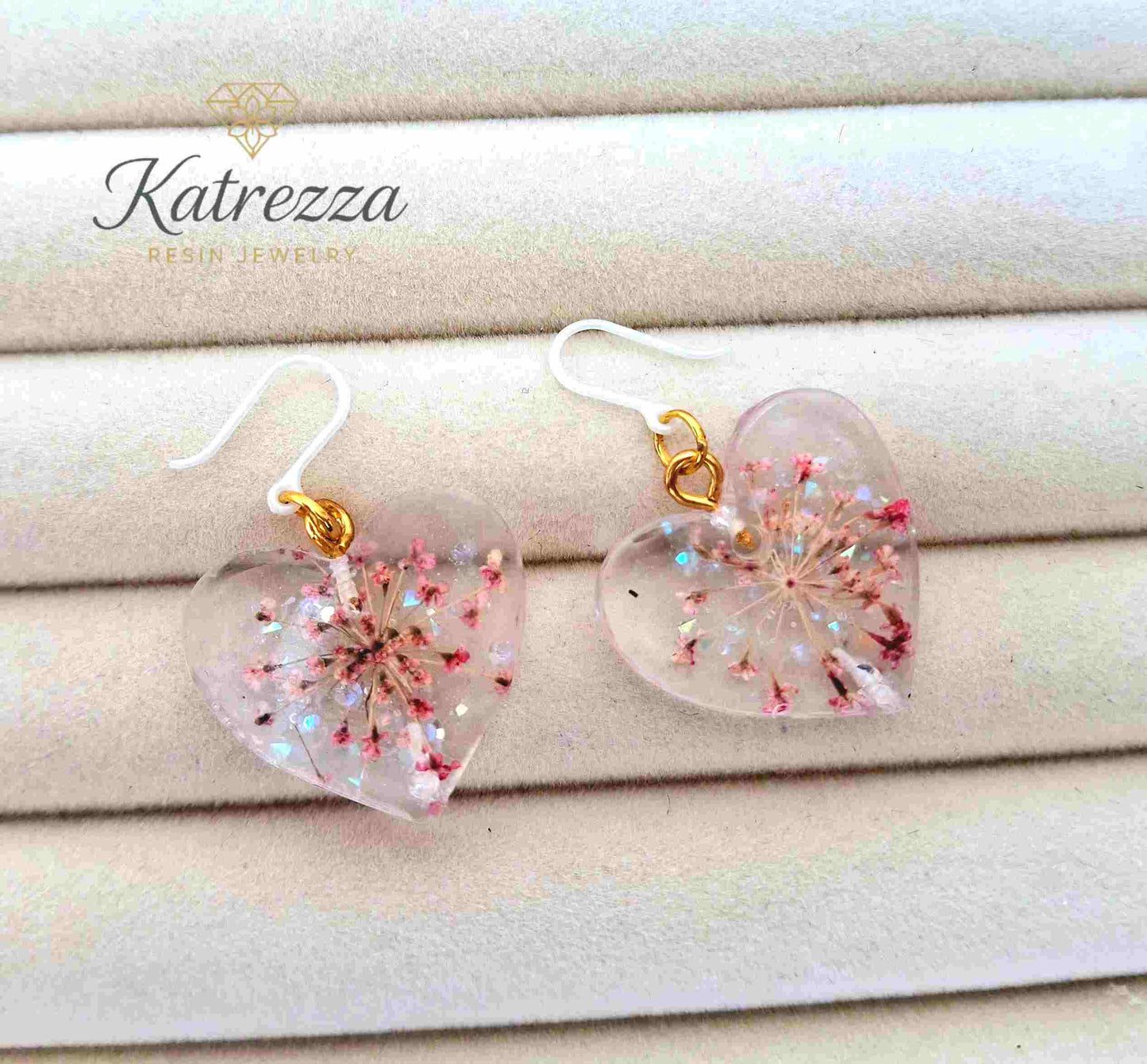 Heart-shaped resin earrings with pink flowers and hypoallergenic silicone hooks