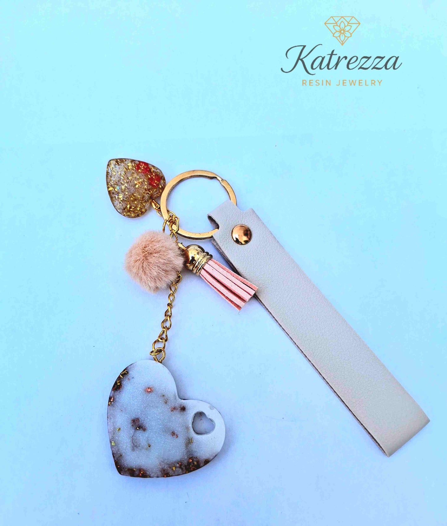 "Close-up of elegant resin heart keychain with butterfly and floral details – Luxurious Collection"