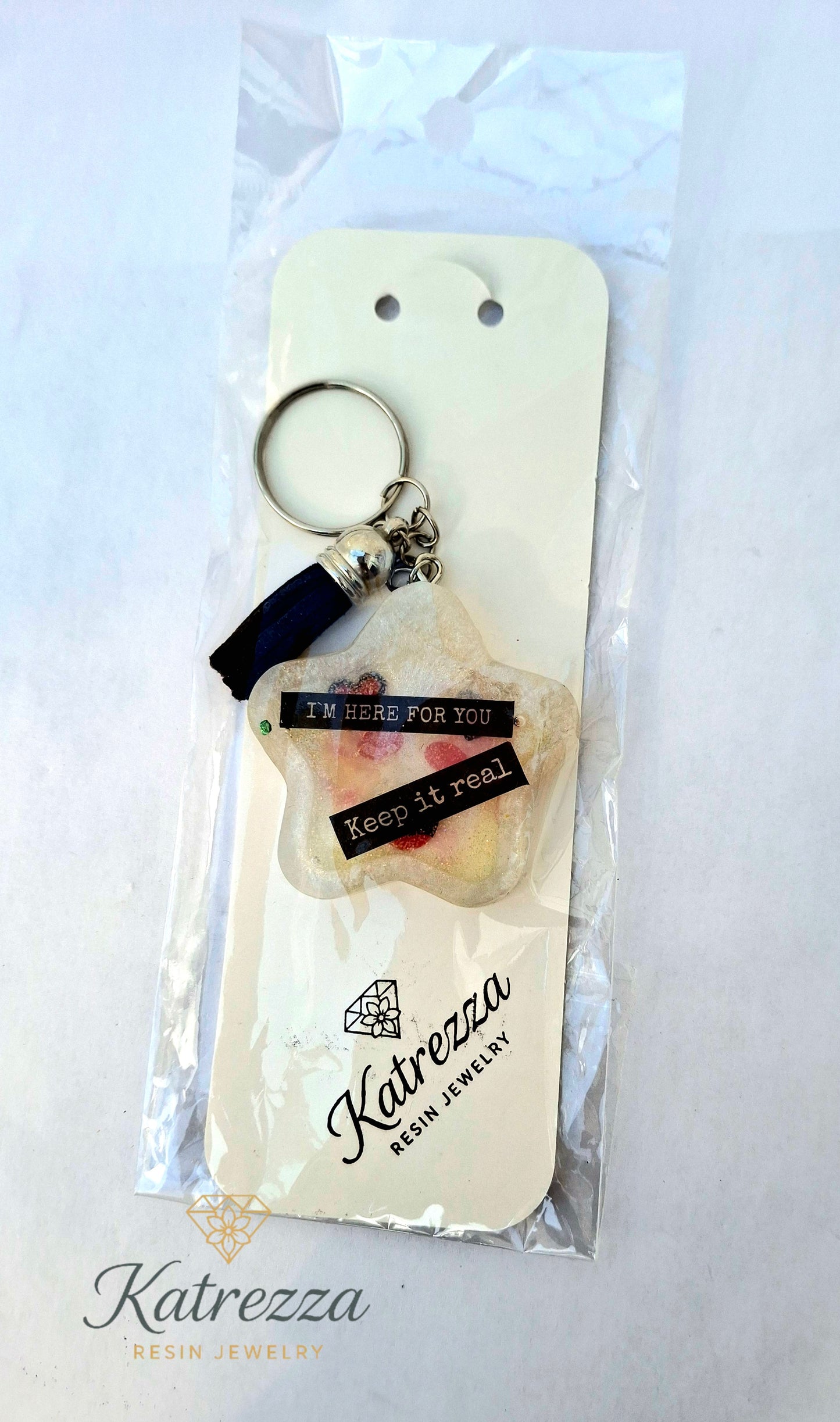 “Handmade star resin keychain with tassel, motivational quotes, in packaging.”