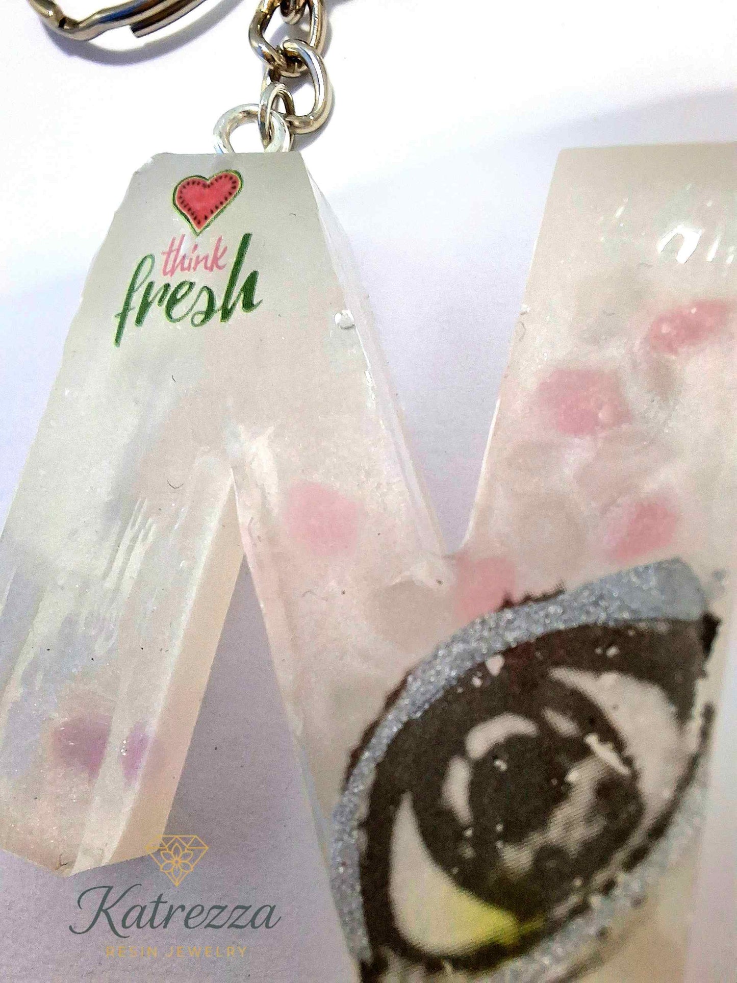 Glow-in-the-dark resin letter N keychain with decorative designs