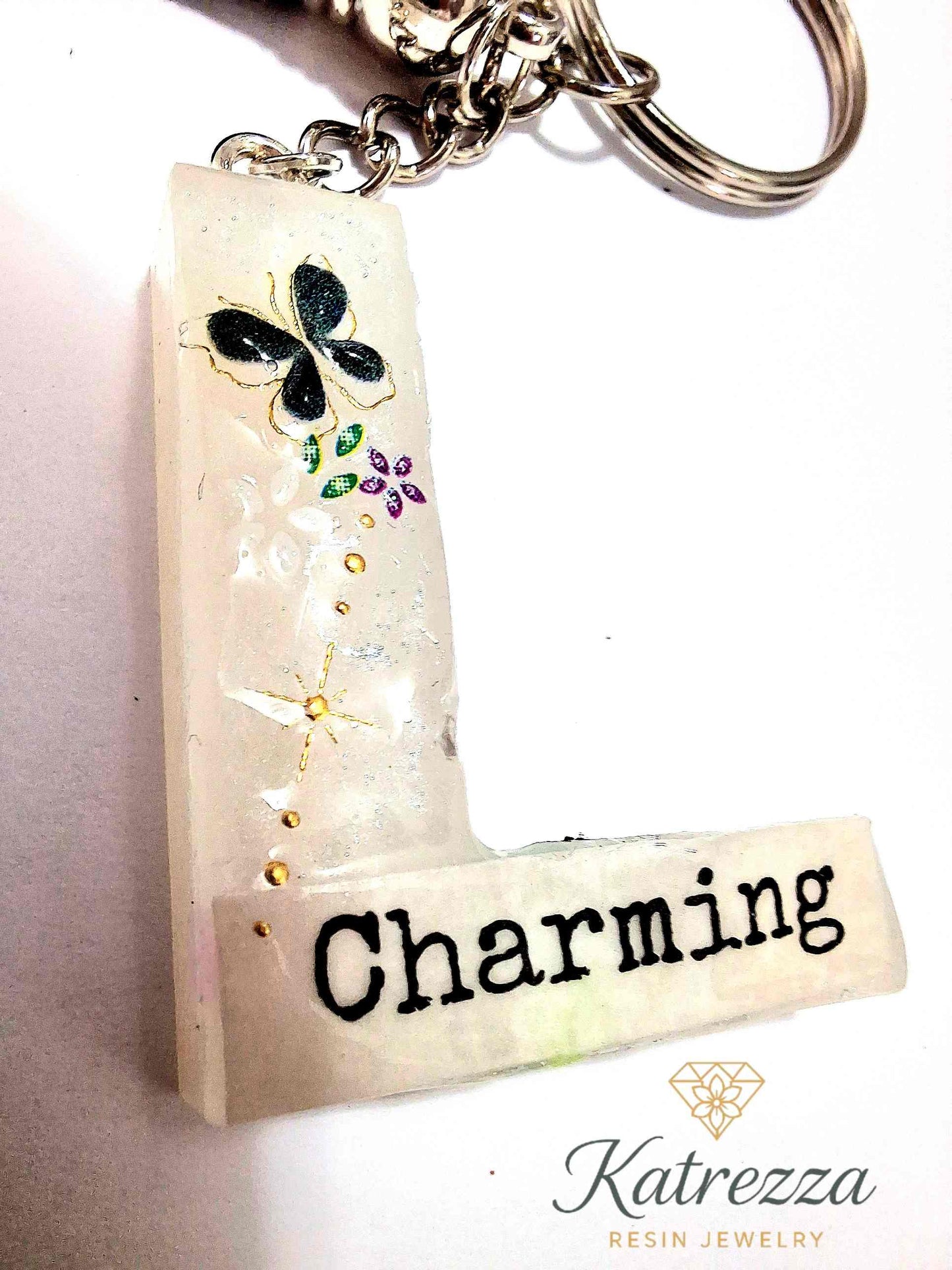 Resin letter L keychain glowing in the dark with tassel.