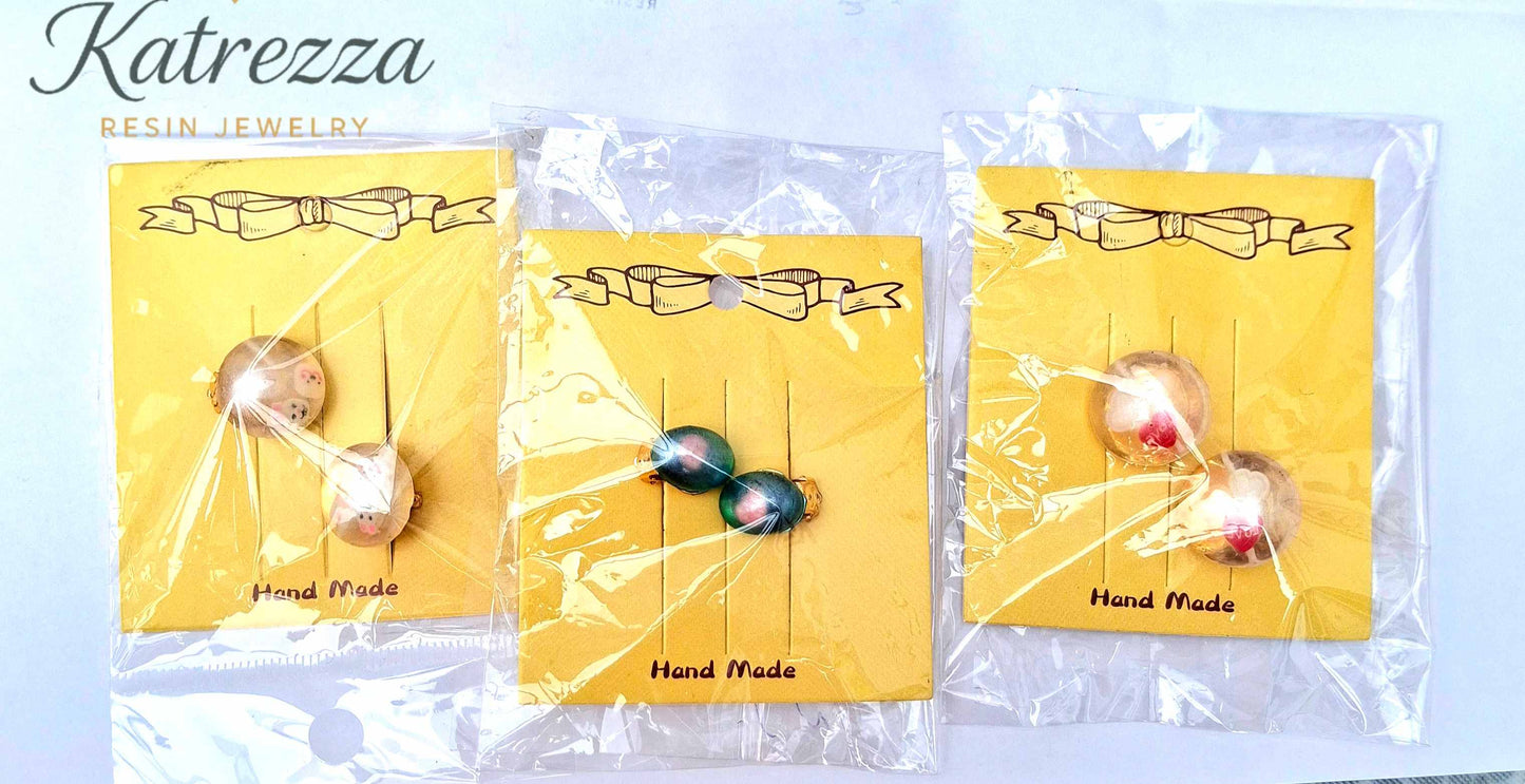“Set of handmade resin clip-on earrings for girls – blue with pink design, safe play jewellery.”