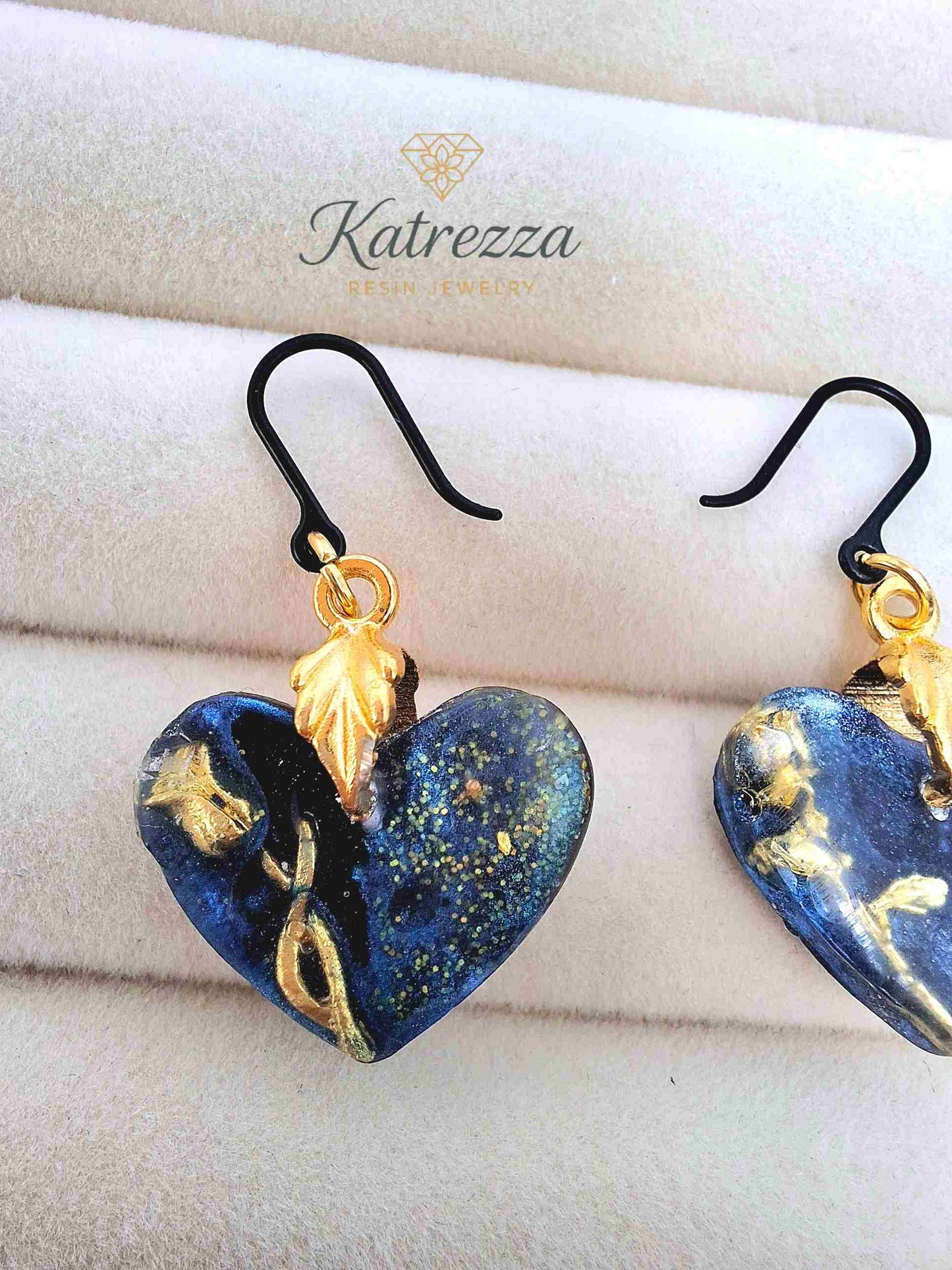 "Close-up of 2.5cm blue resin heart earring with golden rose detail and hypoallergenic silicone hook – Katrezza Girls Collection"