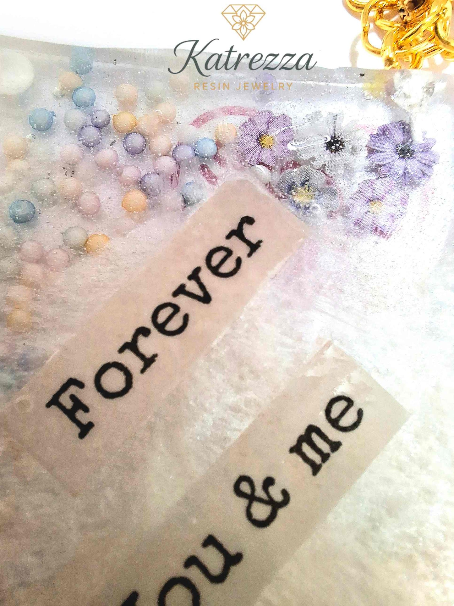Close-up of resin rectangle showing red “Love You” design with confetti details.