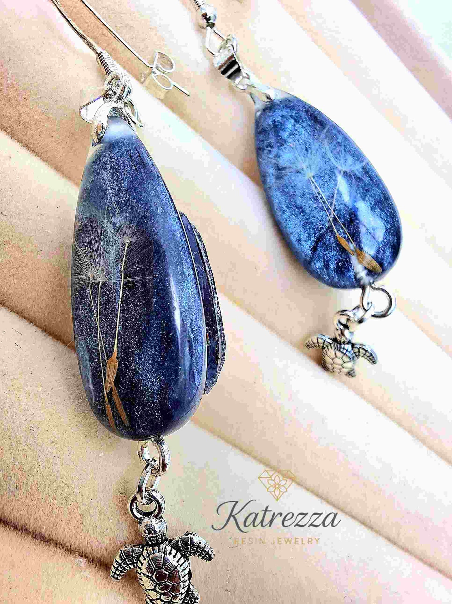 Sterling silver hook and stopper detail on dandelion resin earrings.