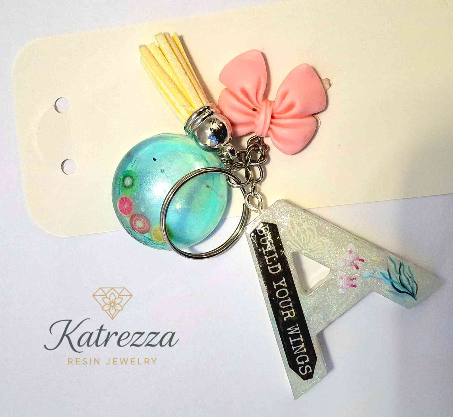 Close-up of resin A keychain showing butterfly stickers and glitter details