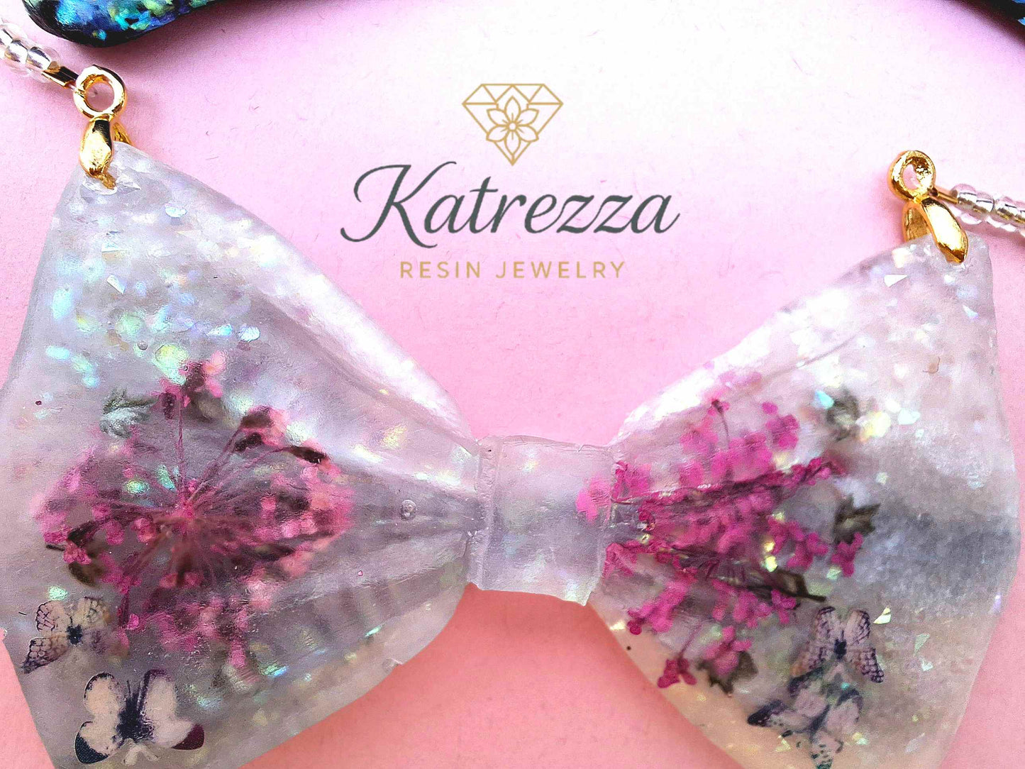 Close-up resin necklace with pink flowers glitter