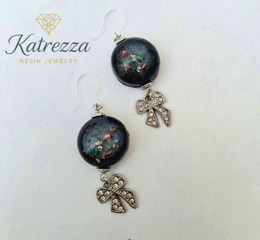 Handmade resin earrings with real flowers and silver bow charm on hypoallergenic hooks
