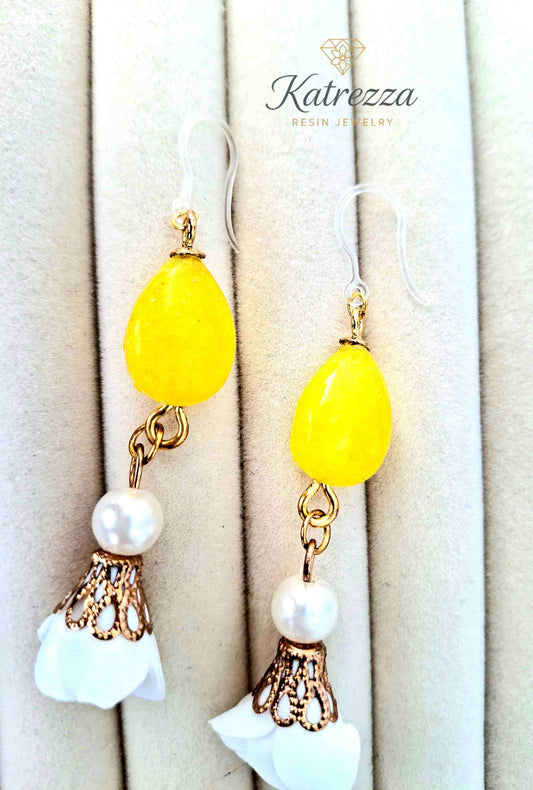 "Close-up of handmade yellow resin drop earrings with pearl beads and hypoallergenic hooks – Katrezza Jewelry"