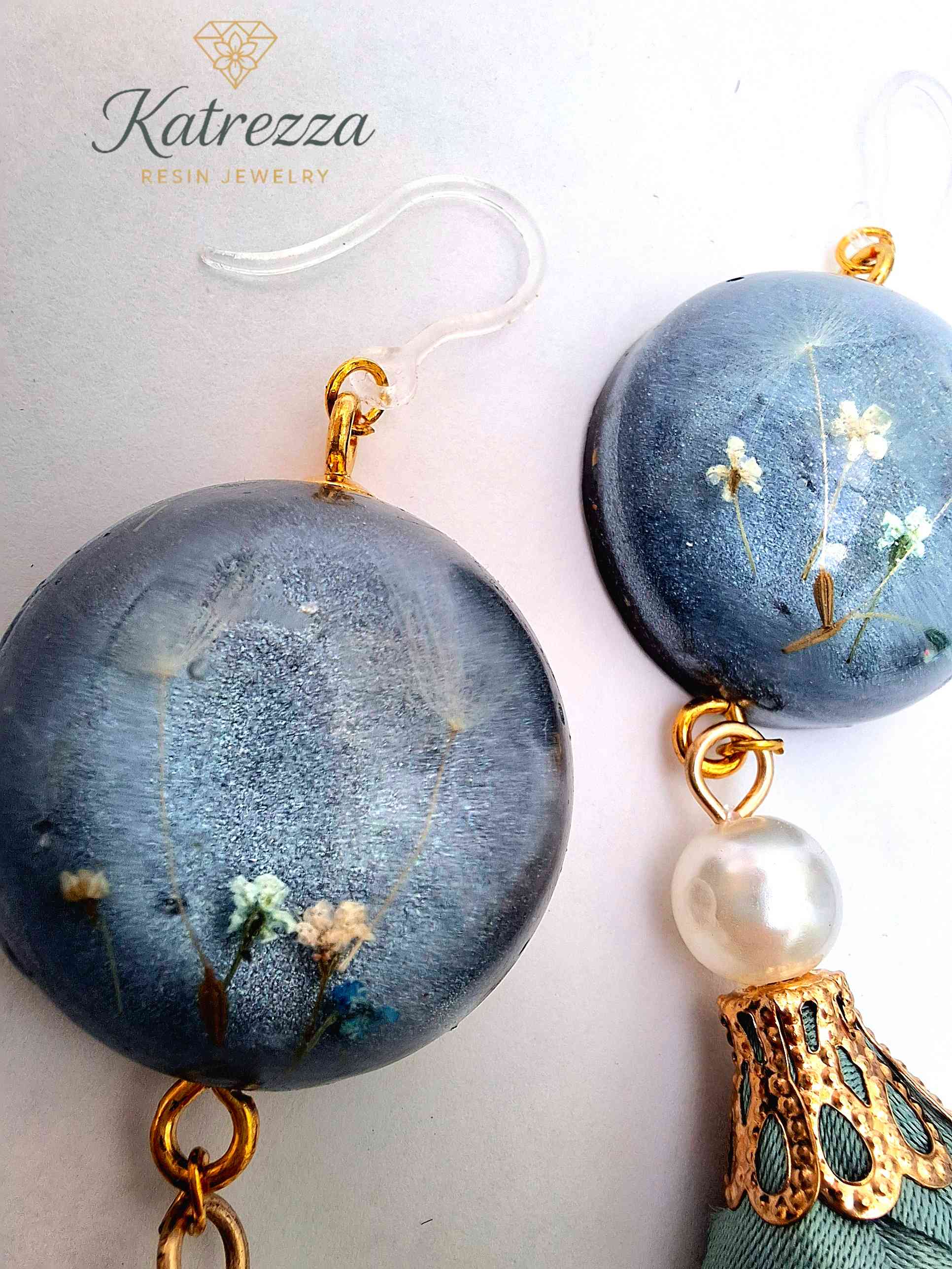 “Pair of handmade resin earrings with flowers inside resin, pearl accent, and green tassel, hypoallergenic hooks – lightweight jewelry.”
