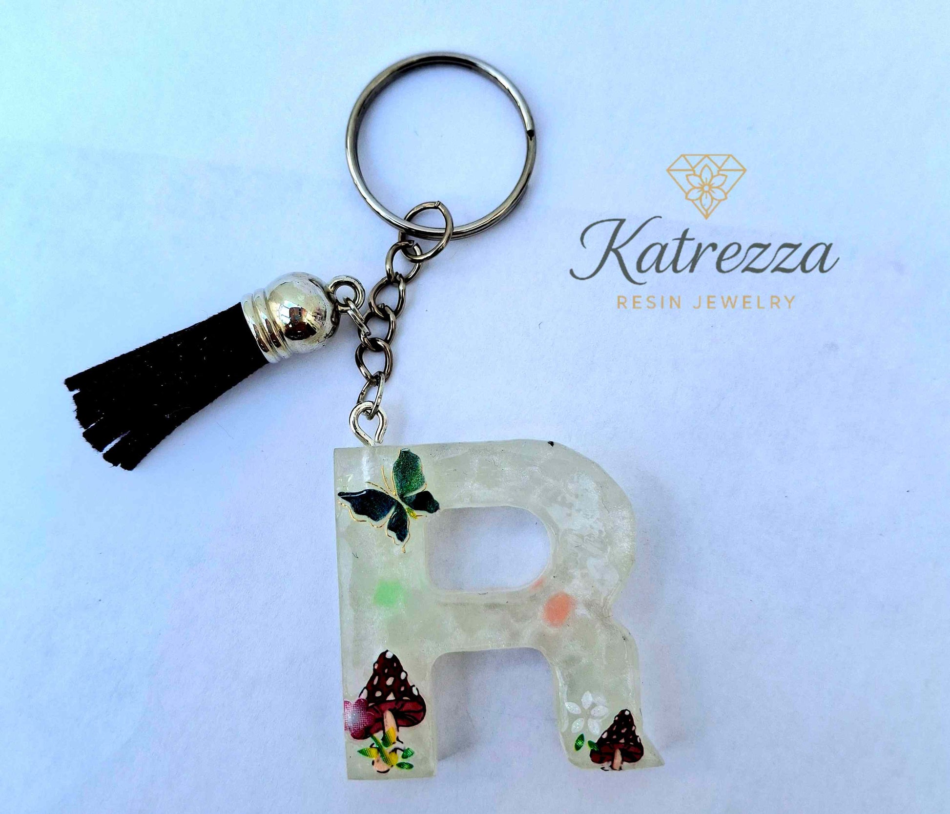 Handmade resin letter R keychain with butterfly and mushroom designs
