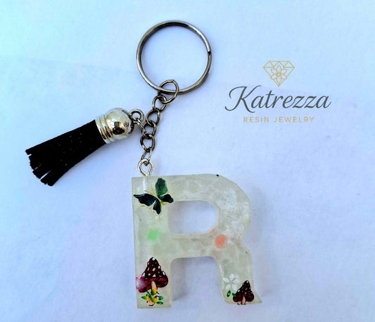 Handmade resin letter R keychain with butterfly and mushroom designs
