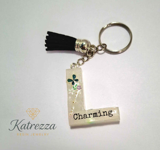 Close-up of Charming resin L keychain with shimmer design.
