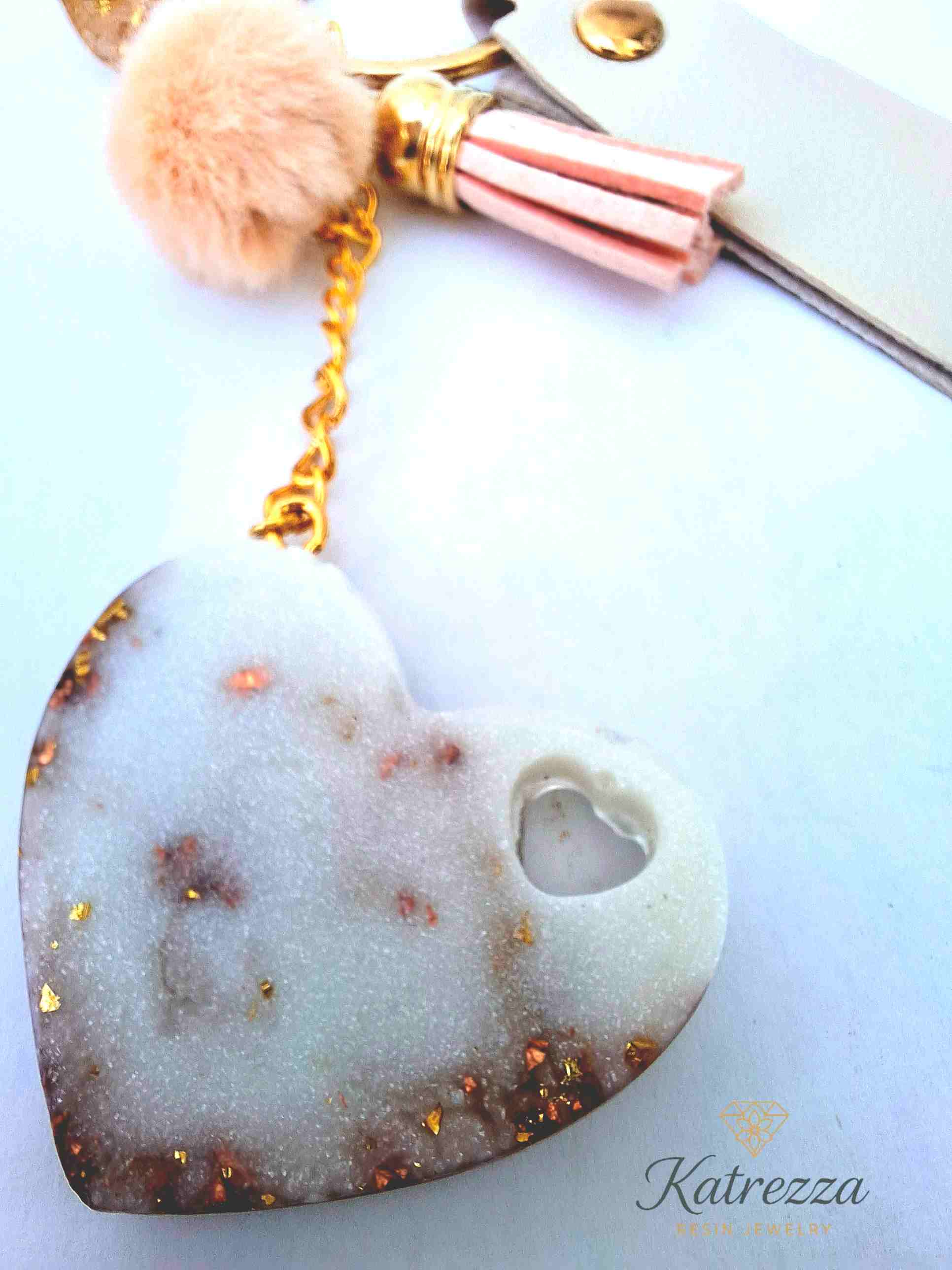 "Back view of resin heart keychain with shimmering gold flakes and heart cutout – Katrezza Luxurious Collection"