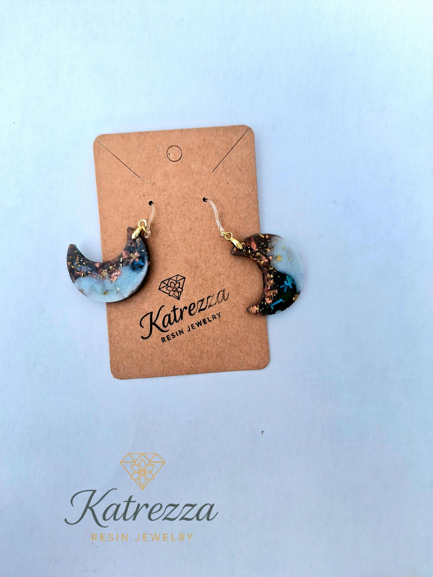 “Handmade crescent moon resin earrings with shimmer effect, double-sided design, 6 cm size, hypoallergenic silicone hooks – Katrezza jewelry.”