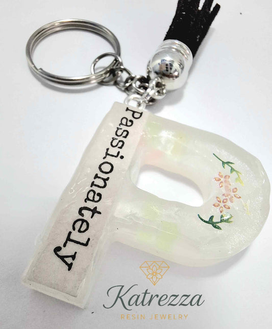Resin letter P keychain with “Passionately” text and floral stickers.
