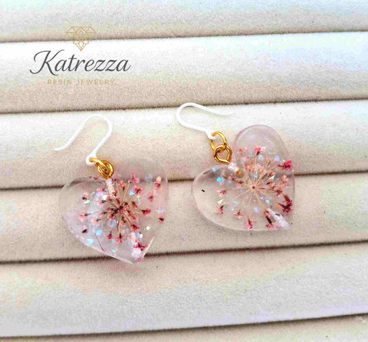 Heart-shaped resin earrings with pink flowers and hypoallergenic silicone hooks