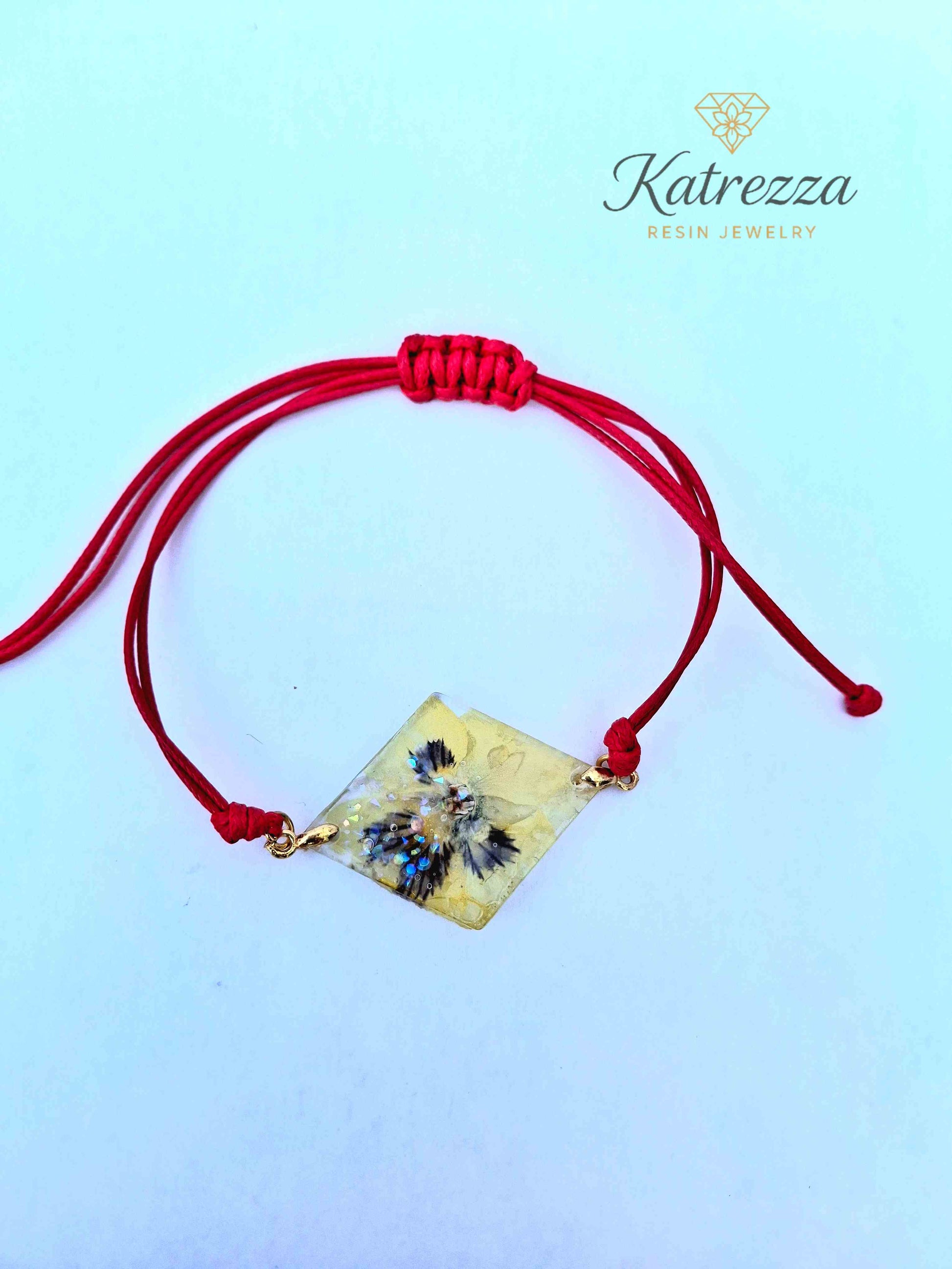 Handmade diamond resin bracelet with real pansy flower inside.
