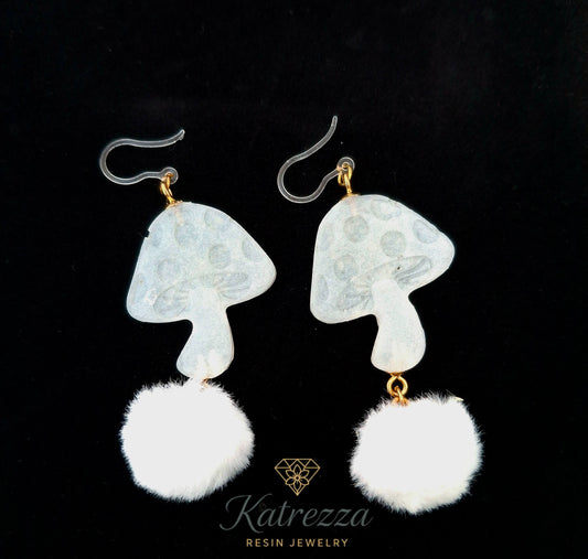“Handmade double-sided mushroom resin earrings – one side with mushroom design, the other with real preserved flowers, plus fluffy white pom-poms.”
