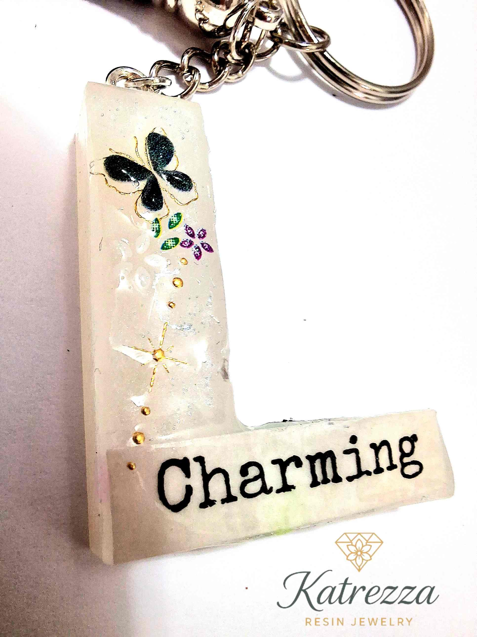 Resin letter L keychain glowing in the dark with tassel.
