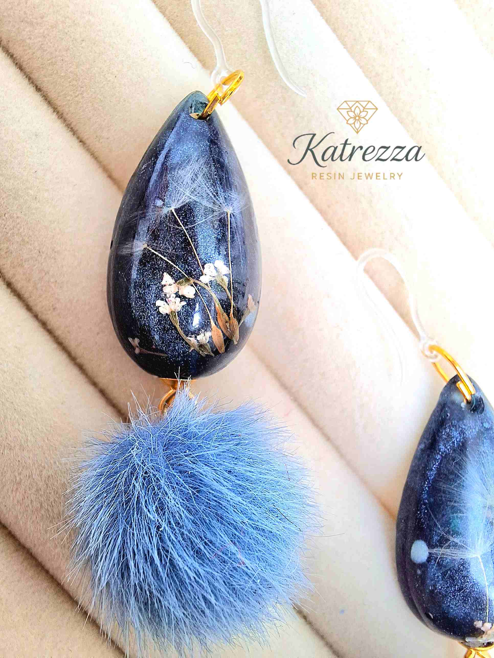 "Dark glittery resin teardrop earrings with real dried flowers and dandelion seeds, finished with blue pom-poms – Katrezza Resin Jewelry"
